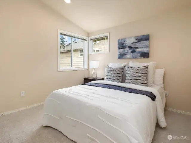 Private bedroom with walk in closet and vaulted ceilings