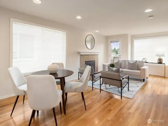 Bright and cozy living room with a gas fireplace and a balcony with territorial views