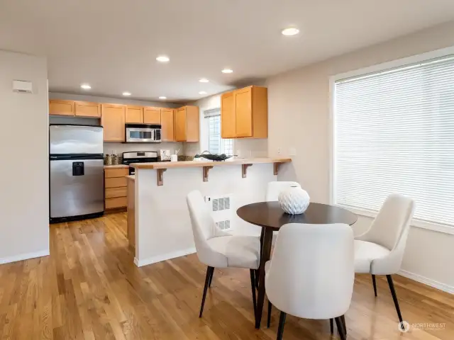 Spacious kitchen with a pantry closet, breakfast bar, and gas range