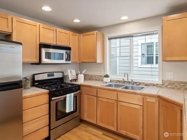 Spacious kitchen with a pantry closet, breakfast bar, and gas range