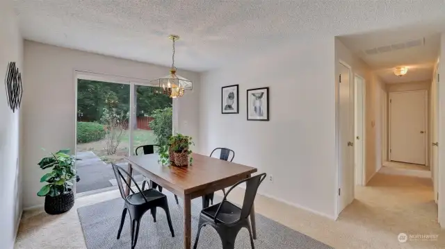 Enjoy hosting in this spacious dining room just steps from the kitchen with direct access to the back yard and patio, great for entertaining.