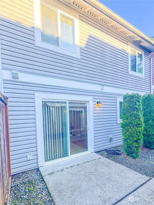 Back entry, sliding glass door and patio.