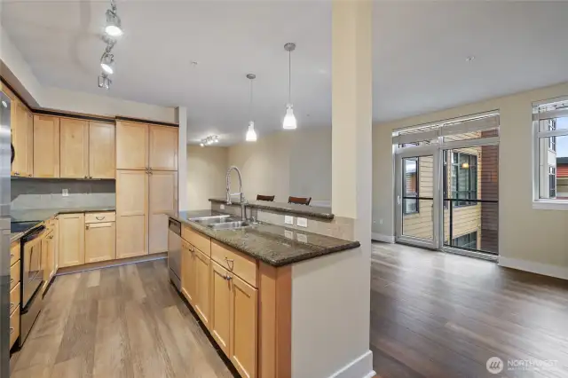 Fresh laminate floors contrast nicely with kitchen cabinets.