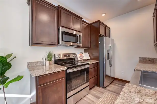 Efficient kitchen layout with ample cabinet space and stainless steel appliances.