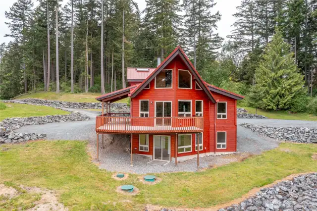 The wall of windows in the main living area gathers all the views and supplies plenty of light all year long. The wrap around deck is perfect for enjoying the view and entertaining!