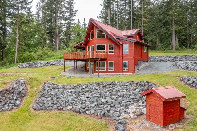 Gorgeous landscaping! With plenty of space for gardening. The small structure is the private well house. This delightful property has no HOA or CCR's.