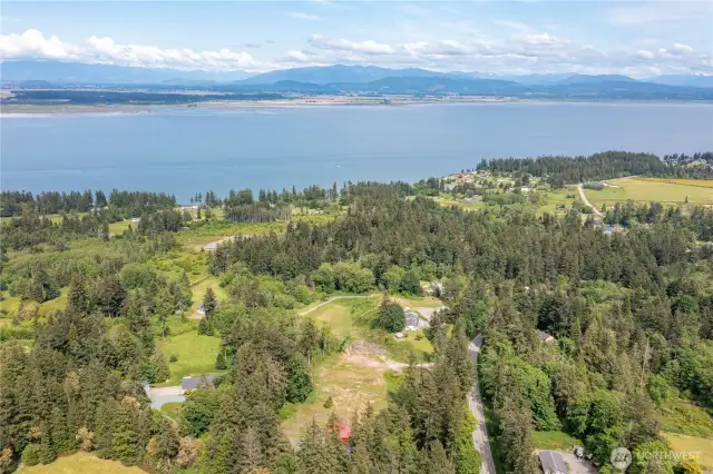 The home is pictured with the red roof at the base of the frame, one can see the magnificent views and area where this uniqe property is located!