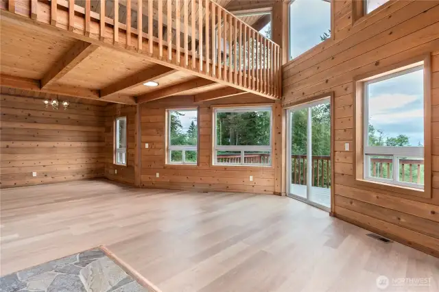 The central living space! The new plank flooring is throughout the main and lower level. The walls are cedar.