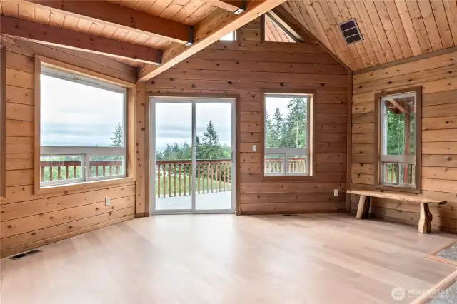 Delightful living space! The wall of windows lets the outside in.