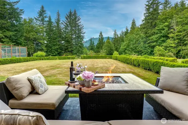 Enjoy the crisp, fresh air sipping coffee ~ heat up around the fire pit with a glass of wine while savoring the majestic views of Mount Si.