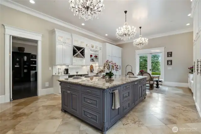 Trash compactor and built-in recycling bin make cleanup effortless. Surrounding the kitchen is a mix of diamond white quartzite countertops and a sprawling Cabernet quartz dining island—which comfortably seats four and includes an in-island sink.