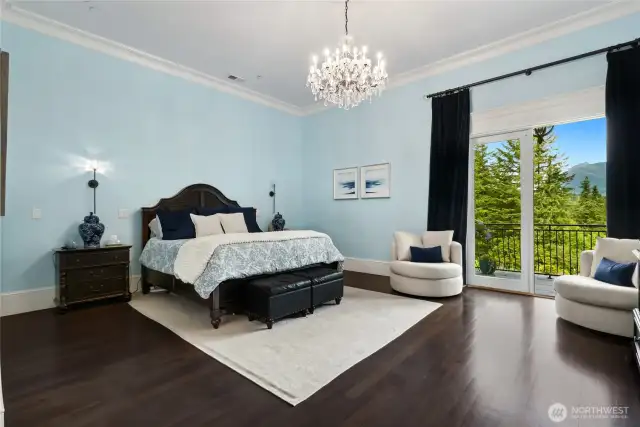 The oversized primary bedroom is a tranquil sanctuary, featuring Brazilian cherry wood floors and double-door access to a private terrace—ideal for sipping morning coffee while taking in the breathtaking, ever-changing views of the gardens and majestic Mount Si.