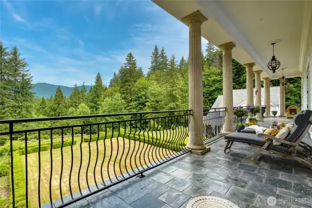 Step through French doors through your private entrance onto the columned, slate-tiled terrace, where stunning panoramic vistas stretch across the mountains, the expansive Pacific Northwest forest, and the beautifully landscaped gardens below. Thoughtfully placed, elegant lighting ensures this serene outdoor retreat is accessible and inviting at any hour or season. Morning coffee is calling.