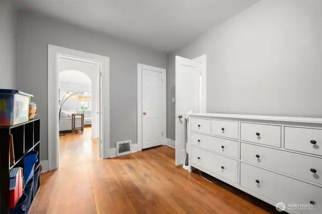 Main floor bedroom opens up to the living space straight ahead, and to the right to the 1/2 bath.