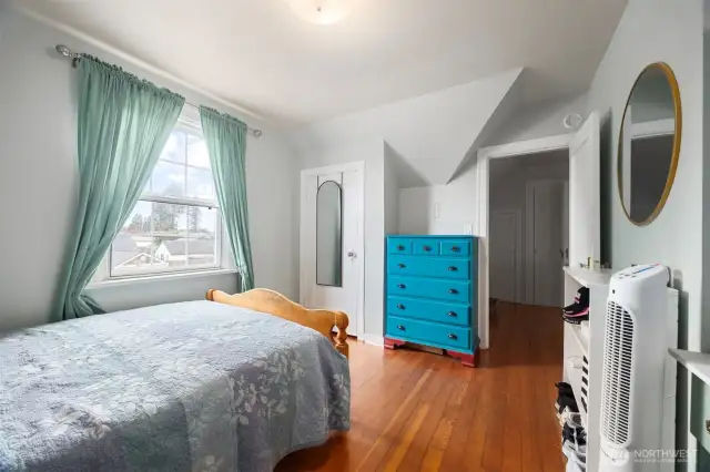 Upper bedroom from an different angle.  Nice roof lines give you style; not just the ordinary box shaped room.  Character abounds in this home in big and small details.