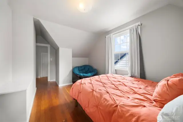2nd view of the bedroom with some nice angles from the roof line.  Enjoy the incredible beauty of the natural wood flooring.