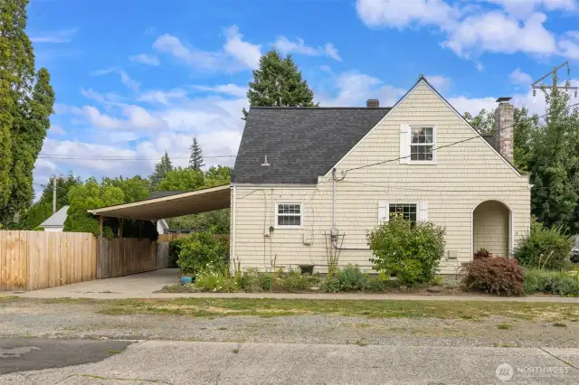 The side view of the house, carport and fenced in back yard. Enjoy some the amazing flowers that will pop up in the spring. Delight in this old fashion flower/herb garden right outside your door.