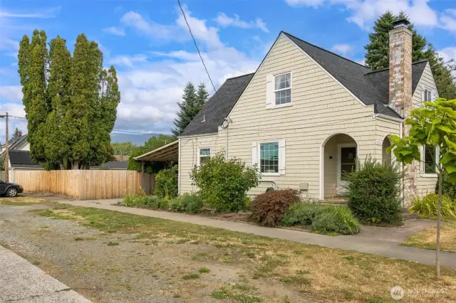 Side yard with plenty of off street parking for your vehicles or your guest vehicles.  Covered porch offers protection as you or your guest enter the front door. Look for the vintage mail slot (a hidden treasure).