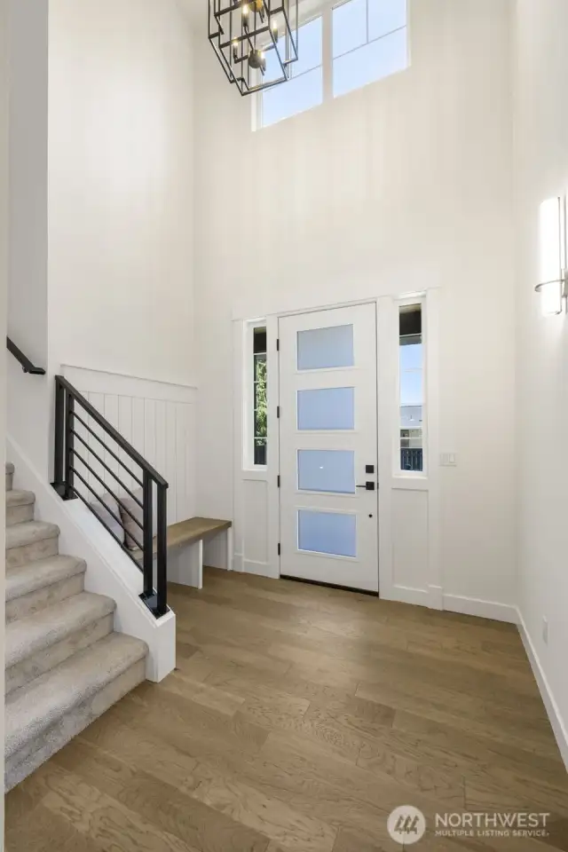 Soaring & bright entry with a gracious custom crafted bench to make it easy for guests to encourage them to help you keep the gorgeous wall to wall  hardwood floors thruout the first floor in like new condition !!