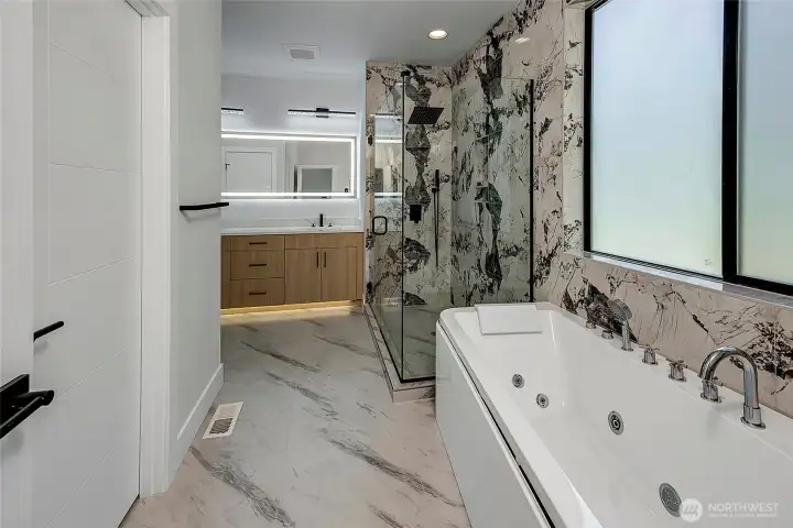 Big and luxurious primary bathroom, full tub and glass shower (virtually staged, photo of similar home in separate community)