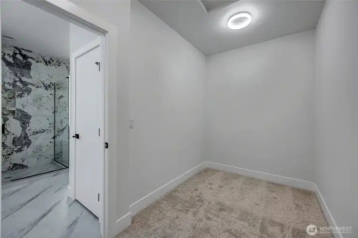 Walk-in closet in primary suite (photo of similar home in separate community)