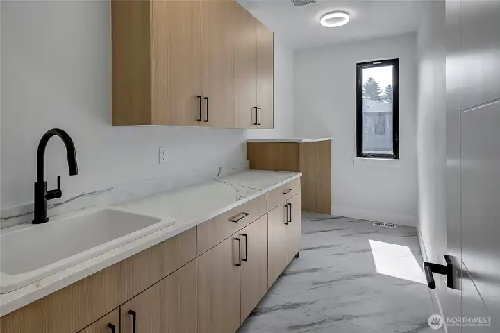 Laundry room with sink located upstairs for convenience (photo of similar home in separate community)