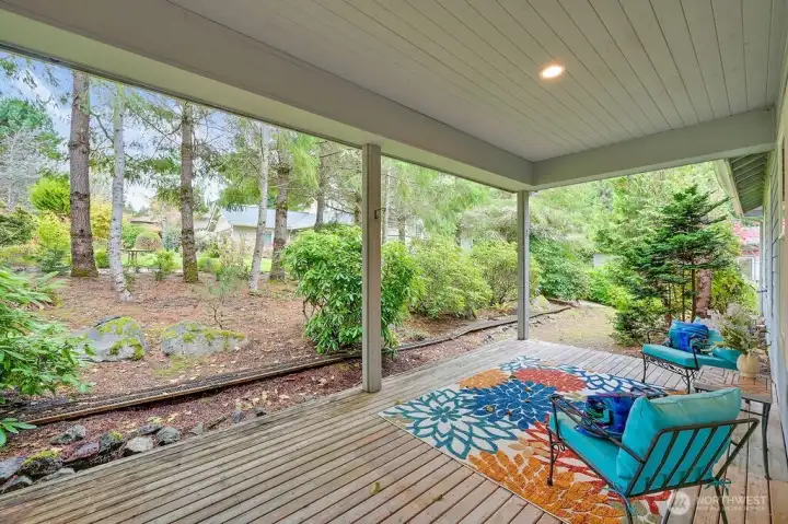 Beautiful setting with this covered deck, doorway leads to living room kitchen.