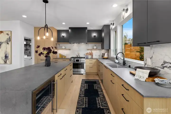 Large chief kitchen with hidden beverage fridge, custom cabinets and paneled appliances