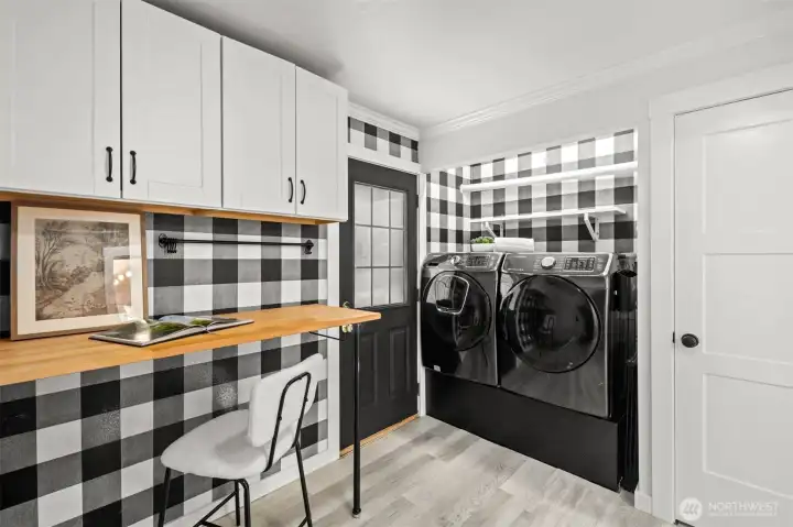 A thoughtfully designed laundry room with abundant storage and plenty of counter space to make laundry day effortless.