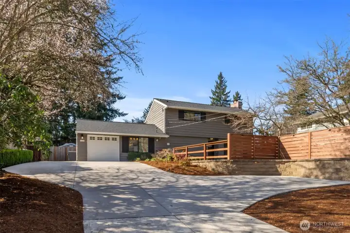 Newly extended driveway, fully fenced, and a flat front yard—perfect for easy parking and curb appeal.
