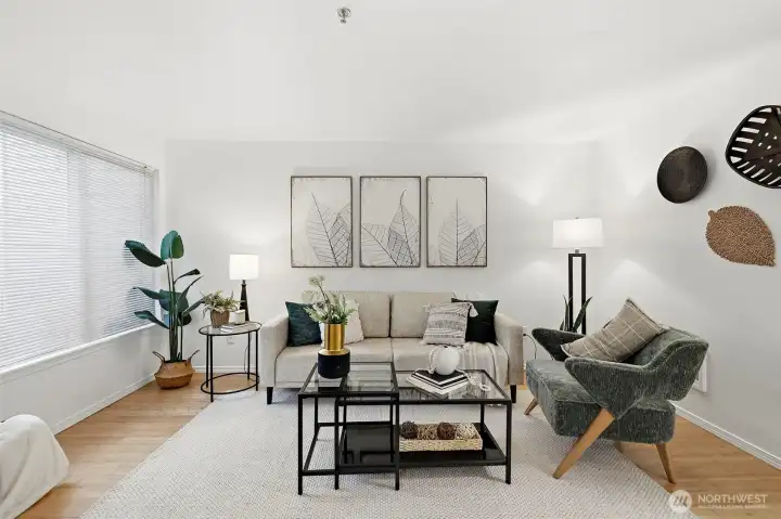 Spacious, light-filled living room with hardwood floors and a clean, open layout — a comfortable everyday retreat.