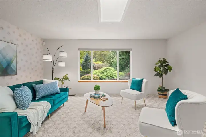 The large picture window looks out to the greenery beyond, bringing in soft light and offering a peaceful sense of privacy and connection to nature.