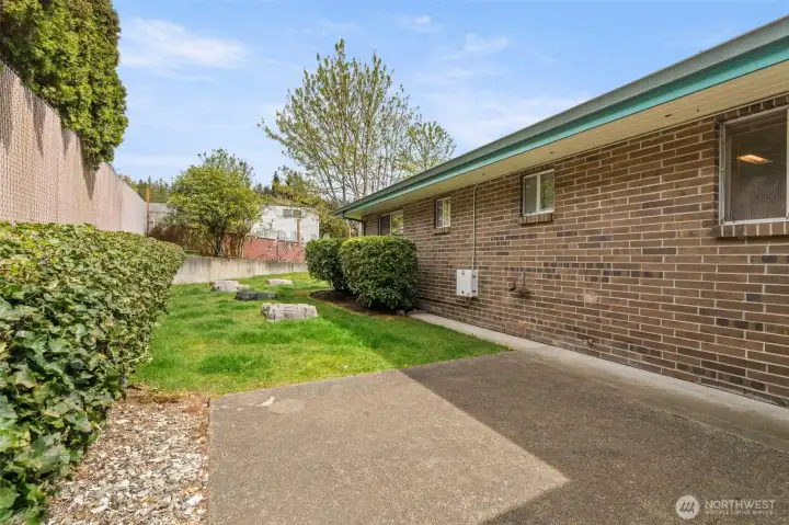 The patio opens out to a lush green lawn, and the entire grassy area is enclosed, creating a great spot for your pup to play and enjoy the outdoors.