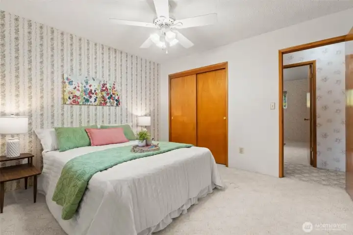 At the other end of the home, you’ll find the first of three bedrooms, offering a quiet and comfortable place to unwind.