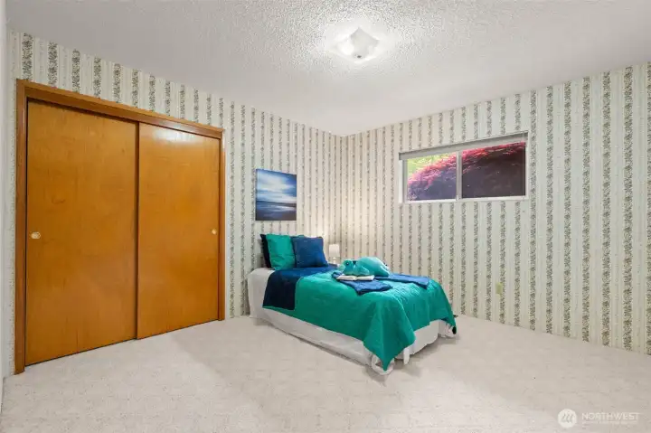 This is the second bedroom, and the view outside is something special… the beautiful Japanese maple brings color and privacy to this bedroom window.