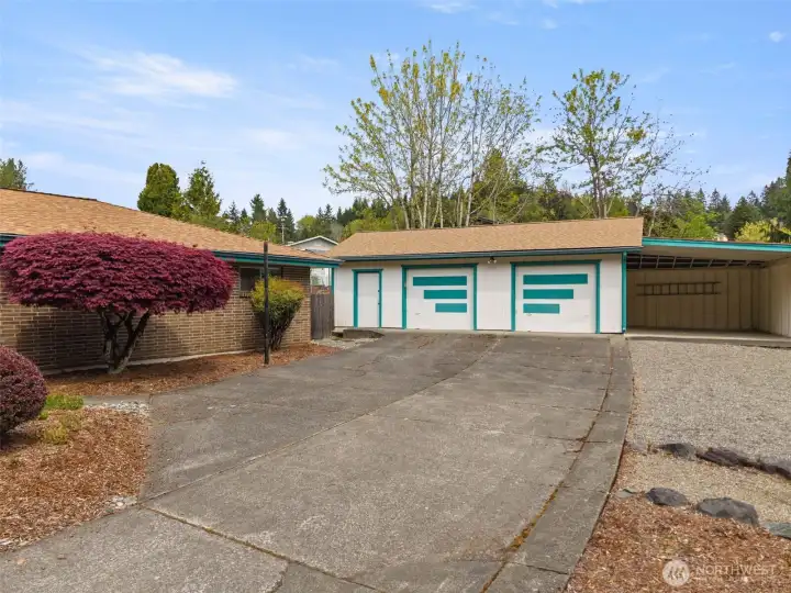 Back outside... wow, just look at the size of this garage! It's 768 square feet! And the carport too -- 300 square feet of covered space, perfect for your boat or trailer!