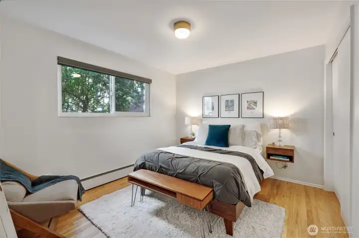 Treed views, a roomy closet, original hardwoods, and built-in side tables - so cute and cozy!
