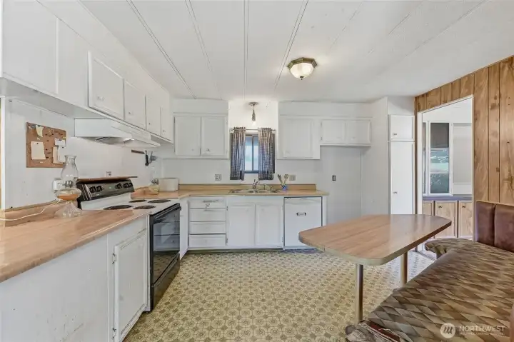 Another view of the kitchen. *Notice some of the bowing in the ceiling above the kitchen sink. This is something that occurs in areas throughout the home.