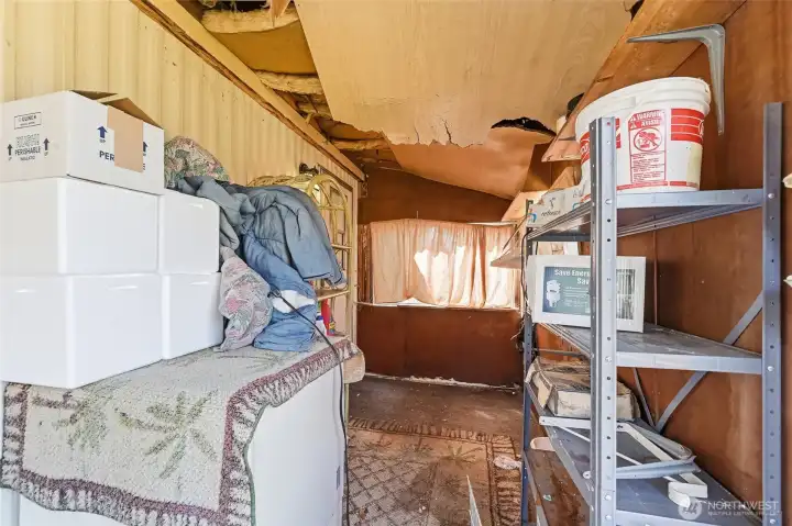 Shed attached to the back side of the home did not have its roof replaced and the ceiling is falling in.*Please note all items in this room remain with the buyer. Shed could be removed completely and stairs added or a new shed added on.
