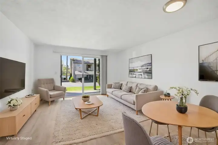 Bright and open dining and living space with access to outdoor patio
