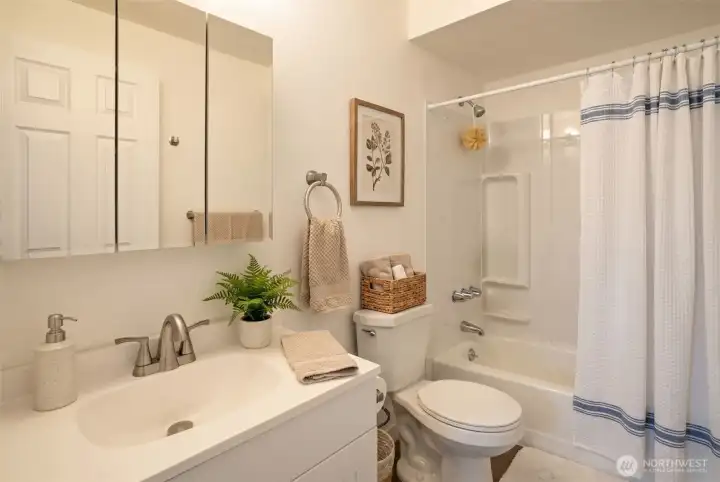 Upgraded bathroom with full tub and shower, and ample vanity and sink