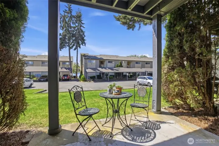 Outdoor patio with room for bbq and outdoor tables.  Laundry, club house and pool are steps away from the back patio.