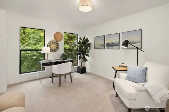 Flexible main floor den or guest room with tranquil greenbelt views and convenient access to the beautifully renovated ¾ bath