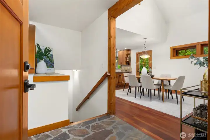 Warm and welcoming entry with soaring ceilings, natural wood details, and an open, inviting layout.