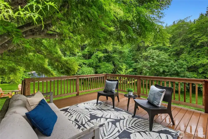 Private deck surrounded by mature trees creates a true Pacific Northwest retreat.