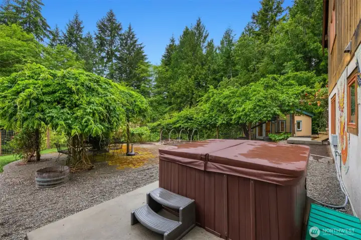 Relax in the hot tub while overlooking your own private oasis.
