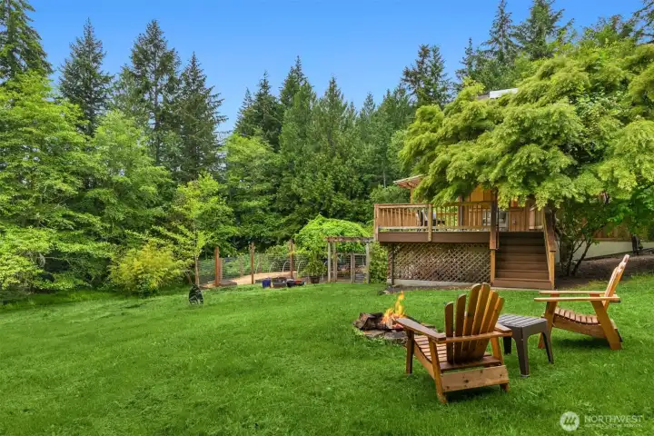Gather with friends around the fire pit, roast marshmallows under the stars, or simply enjoy the serenity of this expansive lawn and natural setting.