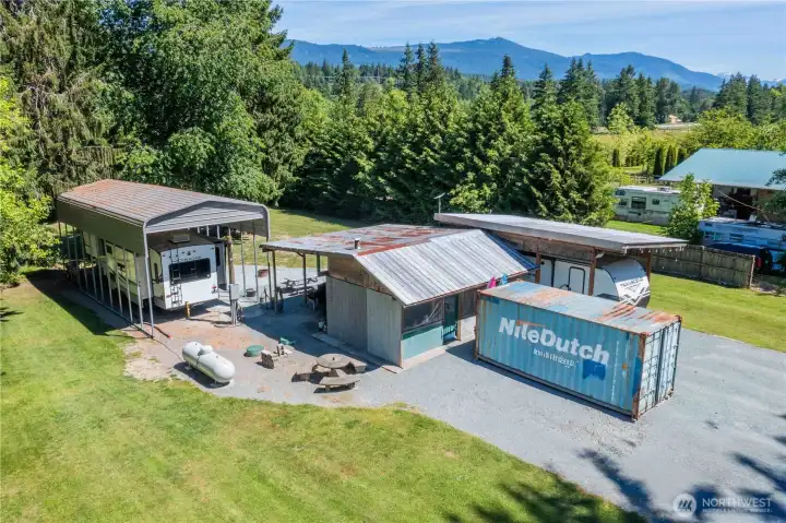 Conex container comes with the property as does the travel trailer under the lean to, the metal RV shelter also is included fully set up for 2 RV's or Tiny home would work