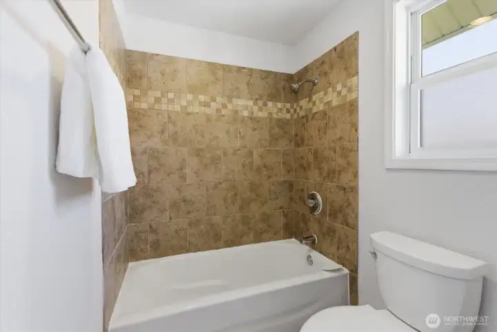beautifully tiled bath surround in the primary on suite
