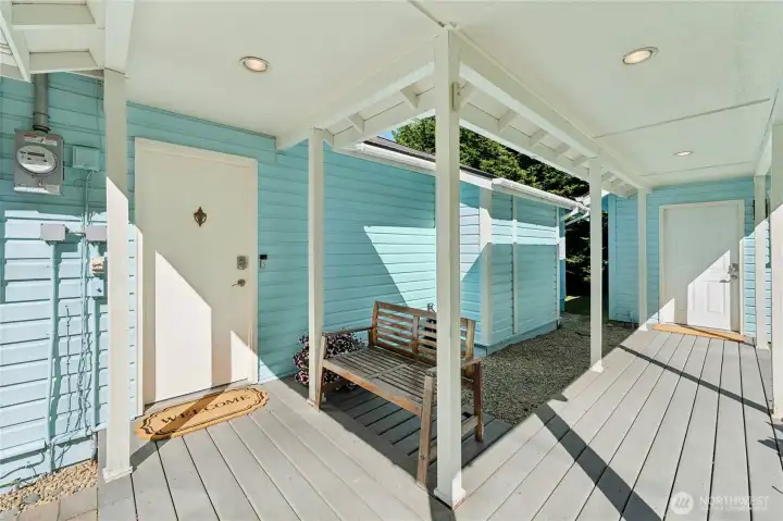 A charming walkway connects the main residence and the attached studio, creating a welcoming arrival to the property.